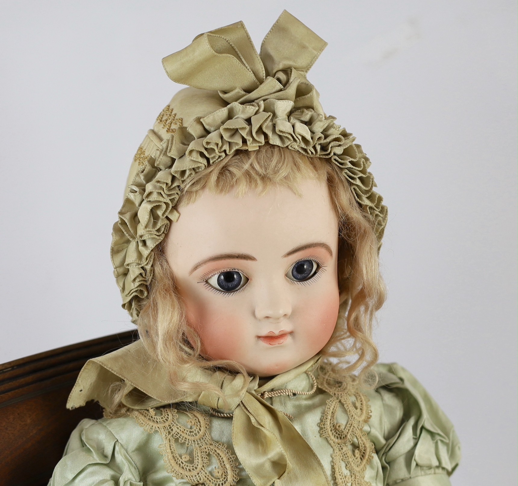 A Jules Steiner Bourgoin bisque doll, French, circa 1880, 24in. Please note the chair is for display purposes only.